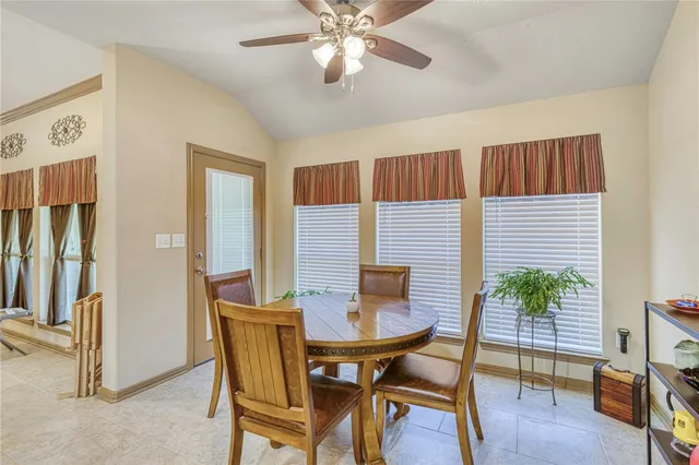 a dining room with furniture and wooden floor