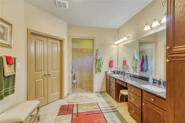 a spacious bathroom with a tub and a mirror