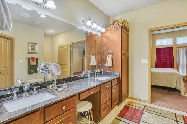 a spacious bathroom with double vanity sinks a large mirror and a shower