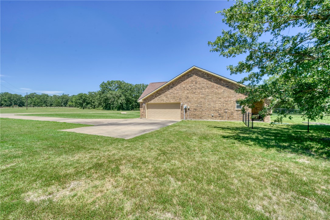 9945 Oxford Cemetery Road Madisonville, TX 77864 - Photo 30 of 42 a view of a house with a yard
