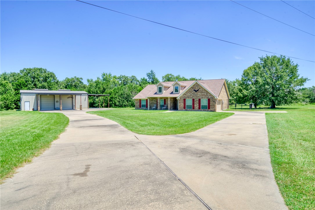 9945 Oxford Cemetery Road Madisonville, TX 77864 - Photo 3 of 42 a view of a house with a yard