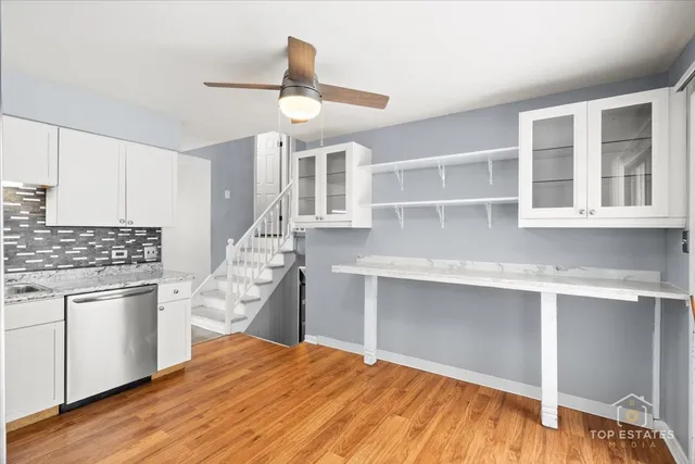 a kitchen with stainless steel appliances granite countertop a refrigerator and stove top oven