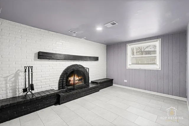 a room with window and a fireplace