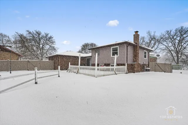 a view of a house with a snow in the background