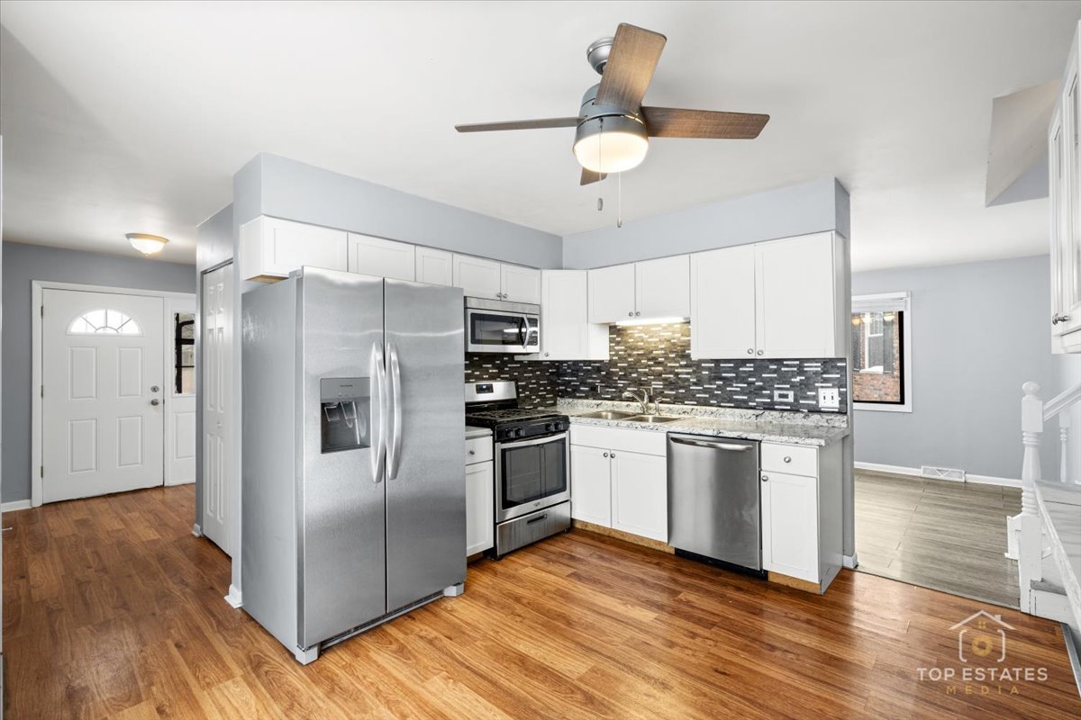 722 Kostner Avenue Matteson, IL 60443 - Photo 10 of 31 a kitchen with stainless steel appliances granite countertop a refrigerator and a stove top oven