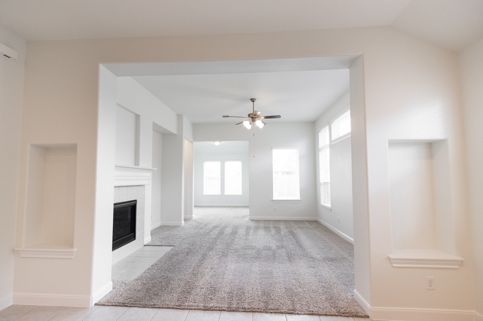 2312 Jessamine Heights Lane Pearland, TX 77089 - Photo 12 of 49 wooden floor in an empty room with a fireplace