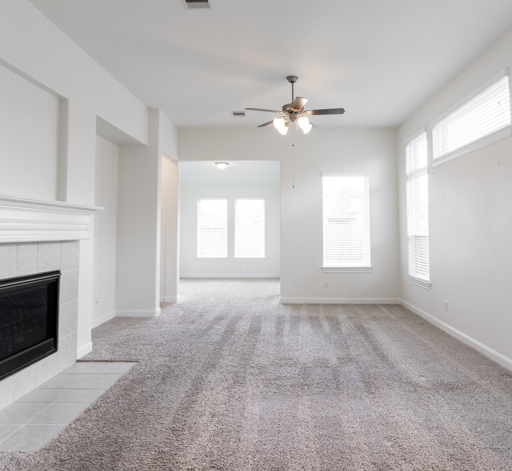 2312 Jessamine Heights Lane Pearland, TX 77089 - Photo 13 of 49 a view of an empty room with chandelier fan and fire place