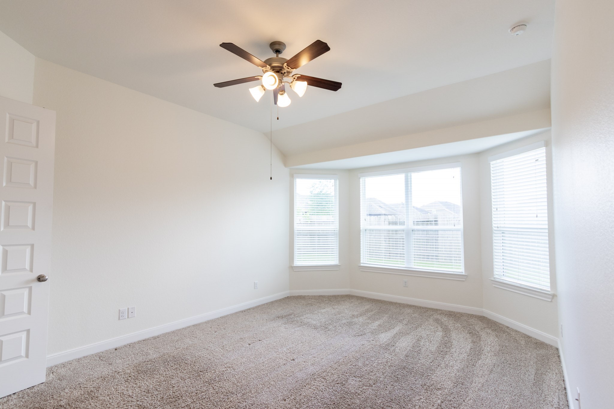 2312 Jessamine Heights Lane Pearland, TX 77089 - Photo 19 of 49 an empty room with windows and chandelier fan