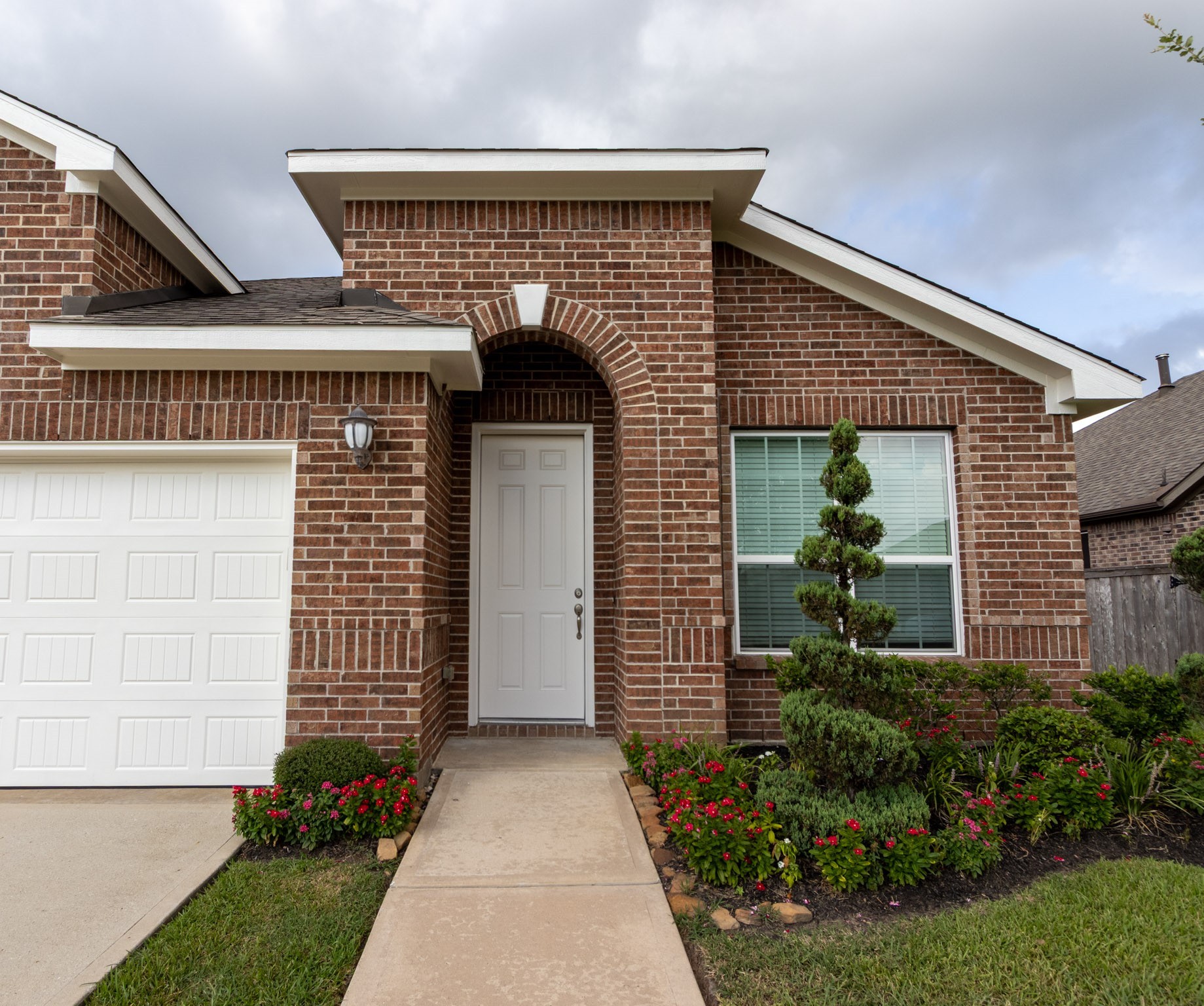 2312 Jessamine Heights Lane Pearland, TX 77089 - Photo 2 of 49 a front view of a house with garden