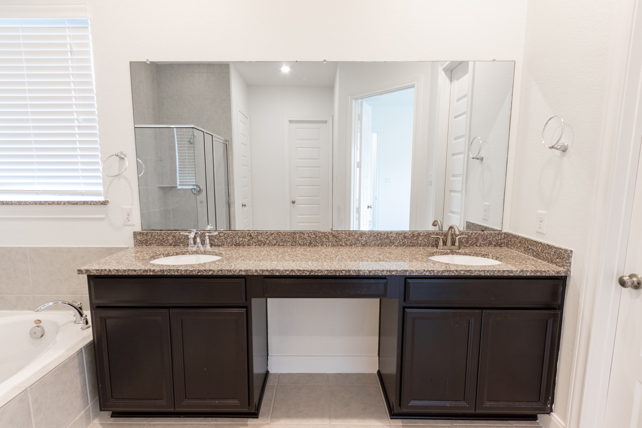 2312 Jessamine Heights Lane Pearland, TX 77089 - Photo 25 of 49 a bathroom with a granite countertop sink a toilet and a large mirror