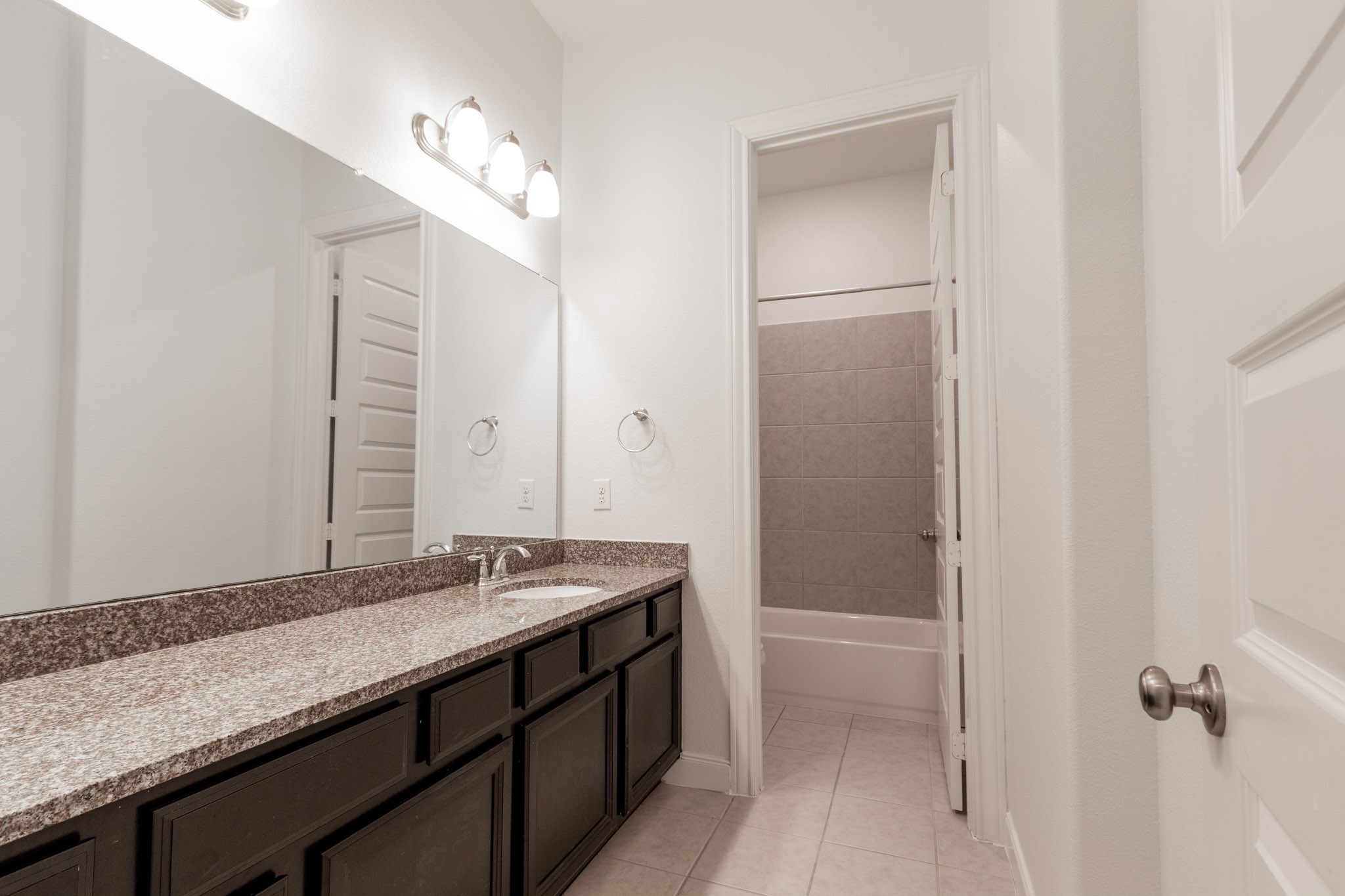 2312 Jessamine Heights Lane Pearland, TX 77089 - Photo 33 of 49 a bathroom with a granite countertop sink and a mirror