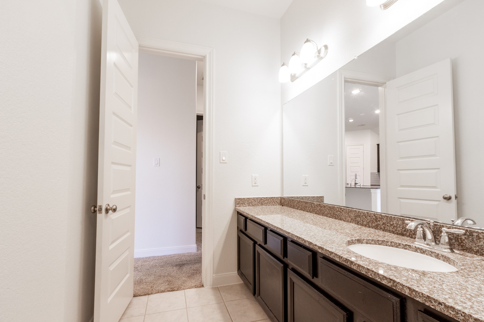 2312 Jessamine Heights Lane Pearland, TX 77089 - Photo 34 of 49 a bathroom with a granite countertop sink and a mirror