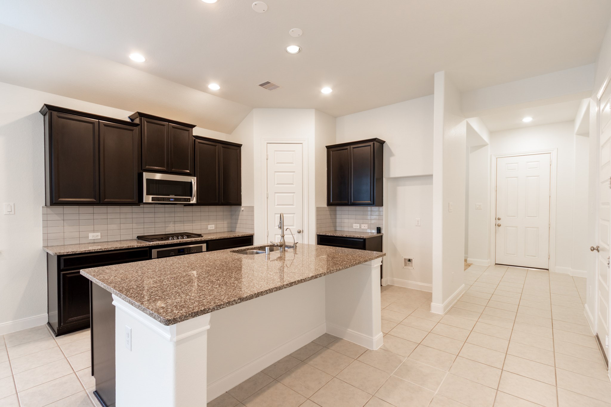 2312 Jessamine Heights Lane Pearland, TX 77089 - Photo 4 of 49 a kitchen with stainless steel appliances granite countertop a sink and a microwave