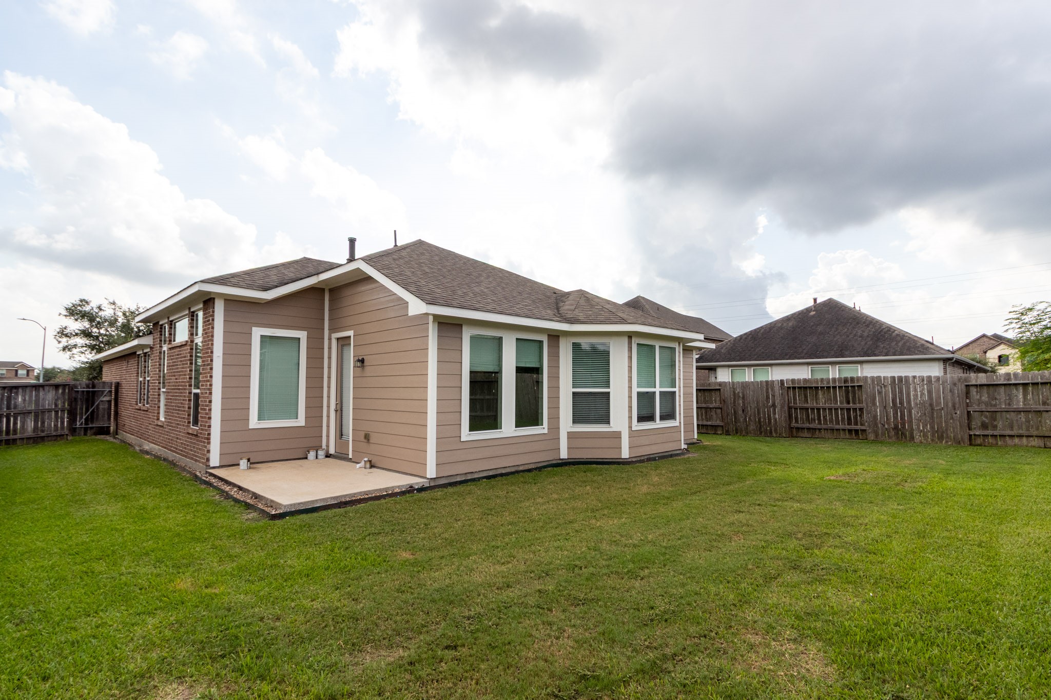 2312 Jessamine Heights Lane Pearland, TX 77089 - Photo 41 of 49 a view of a house with a yard and sitting area
