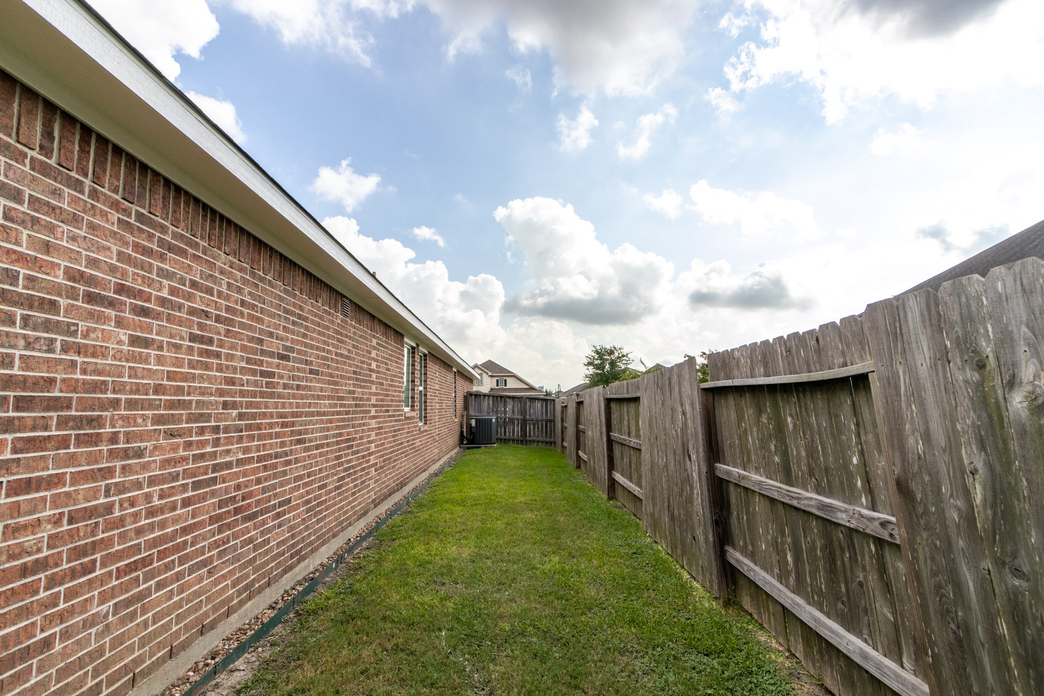 2312 Jessamine Heights Lane Pearland, TX 77089 - Photo 43 of 49 a backyard of a house with lots of green space