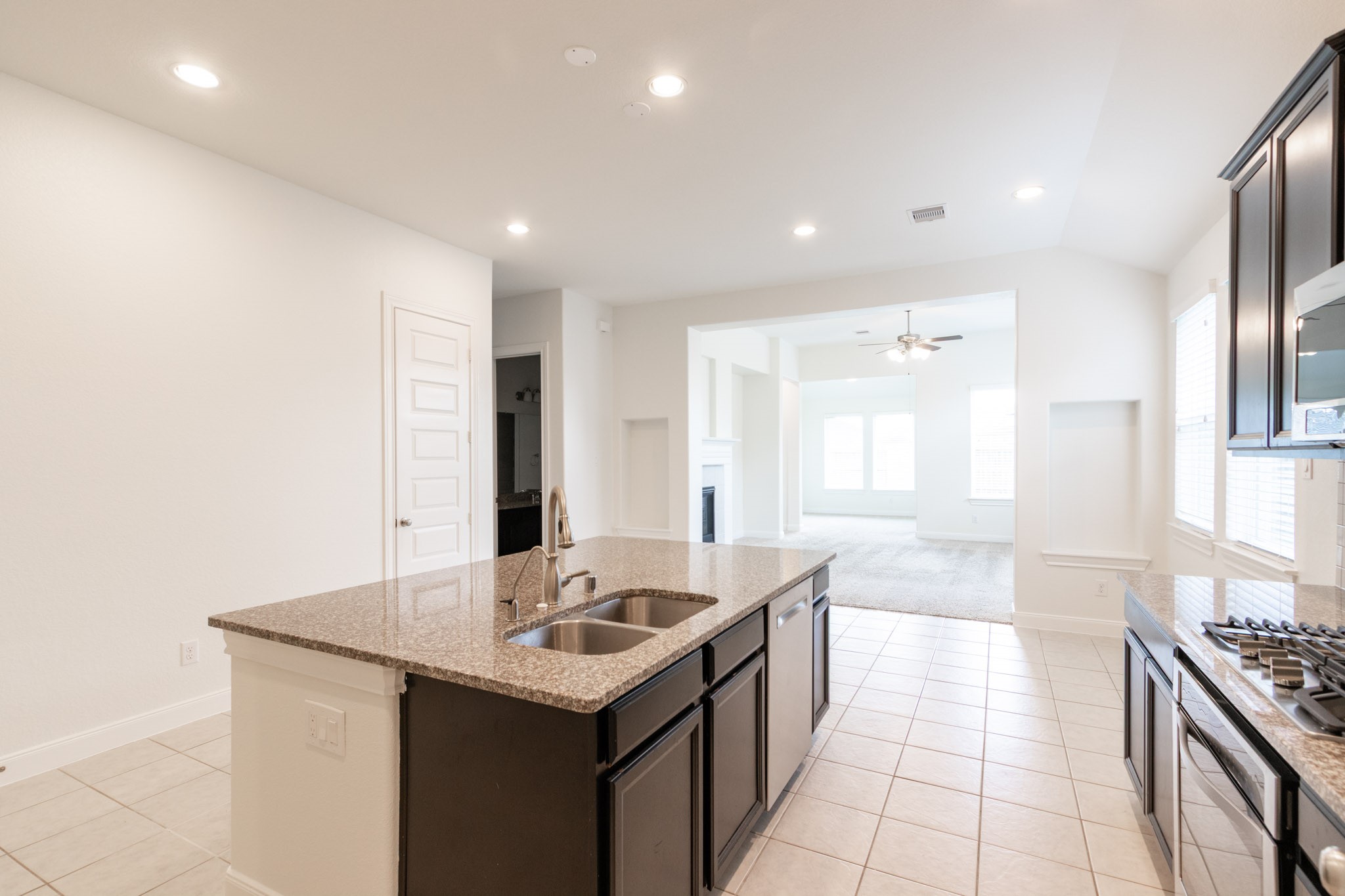 2312 Jessamine Heights Lane Pearland, TX 77089 - Photo 5 of 49 a kitchen with granite countertop a sink and a stove