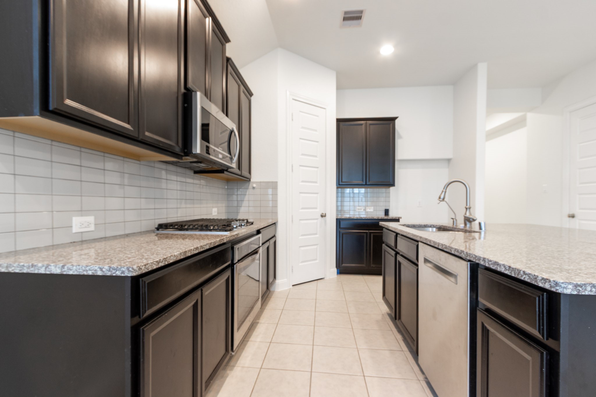 2312 Jessamine Heights Lane Pearland, TX 77089 - Photo 6 of 49 a kitchen with stainless steel appliances granite countertop a sink stove and refrigerator