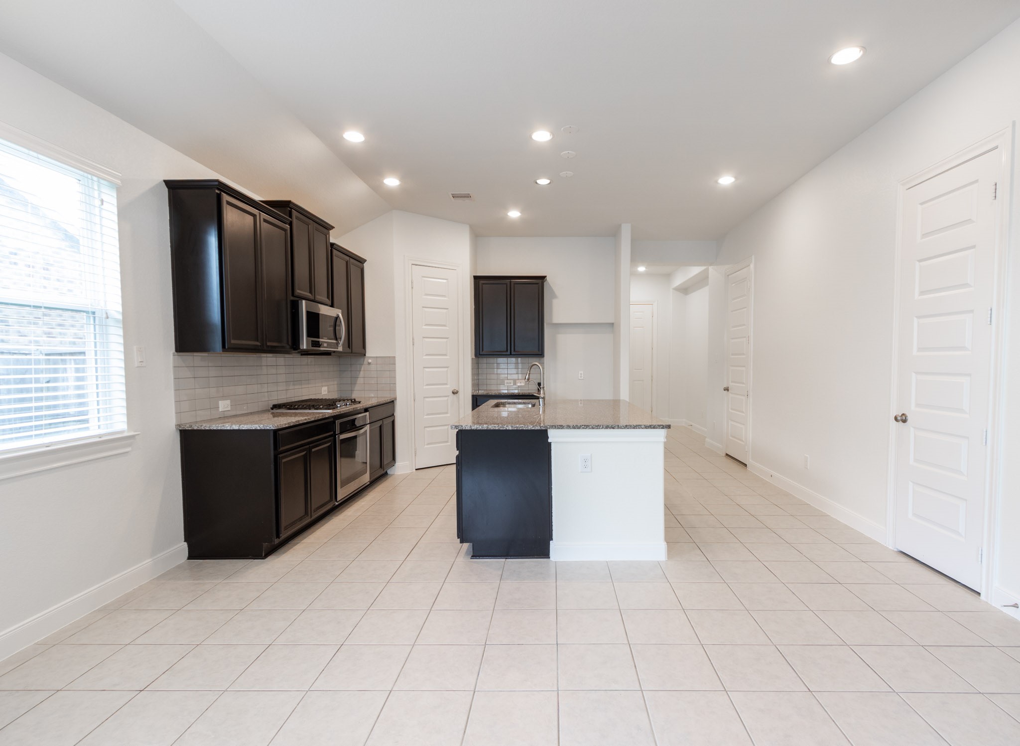 2312 Jessamine Heights Lane Pearland, TX 77089 - Photo 8 of 49 a kitchen with stainless steel appliances granite countertop a refrigerator and a stove top oven