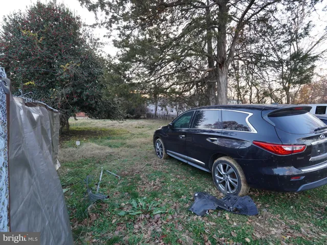 a view of a house with a truck parked in back yard