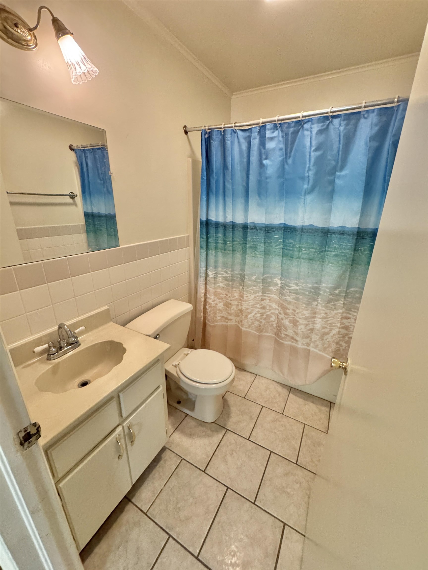 119 Larkwood Avenue Ripley, TN 38063 - Photo 8 of 10 Bathroom featuring crown molding, vanity, tile walls, tile patterned floors, and curtained shower