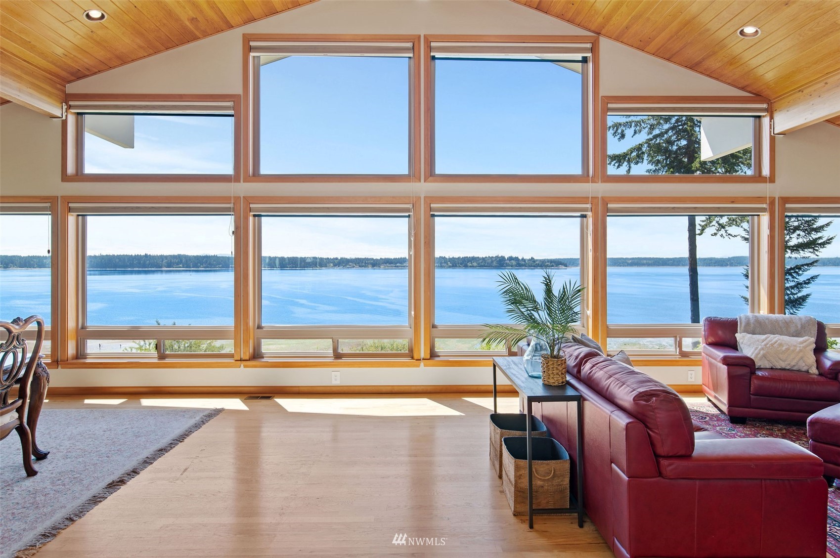 a living room with furniture and floor to ceiling windows