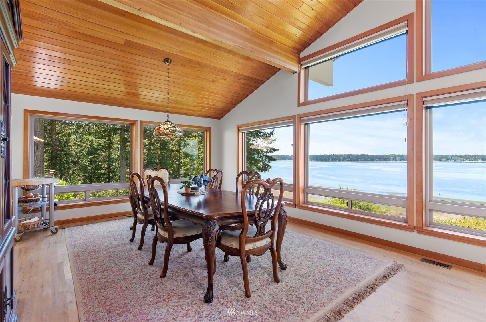 17510 88th Street Southwest Longbranch, WA 98351 - Photo 13 of 40 a dining room with furniture a rug and a large window