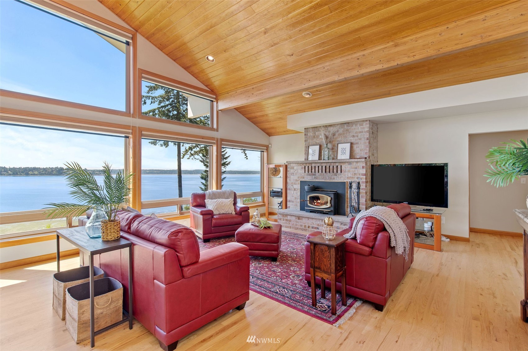 17510 88th Street Southwest Longbranch, WA 98351 - Photo 16 of 40 a living room with furniture a fireplace and a flat screen tv