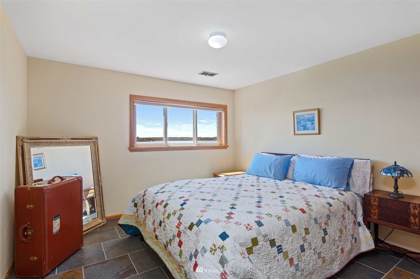 17510 88th Street Southwest Longbranch, WA 98351 - Photo 28 of 40 a bedroom with a large bed and a window