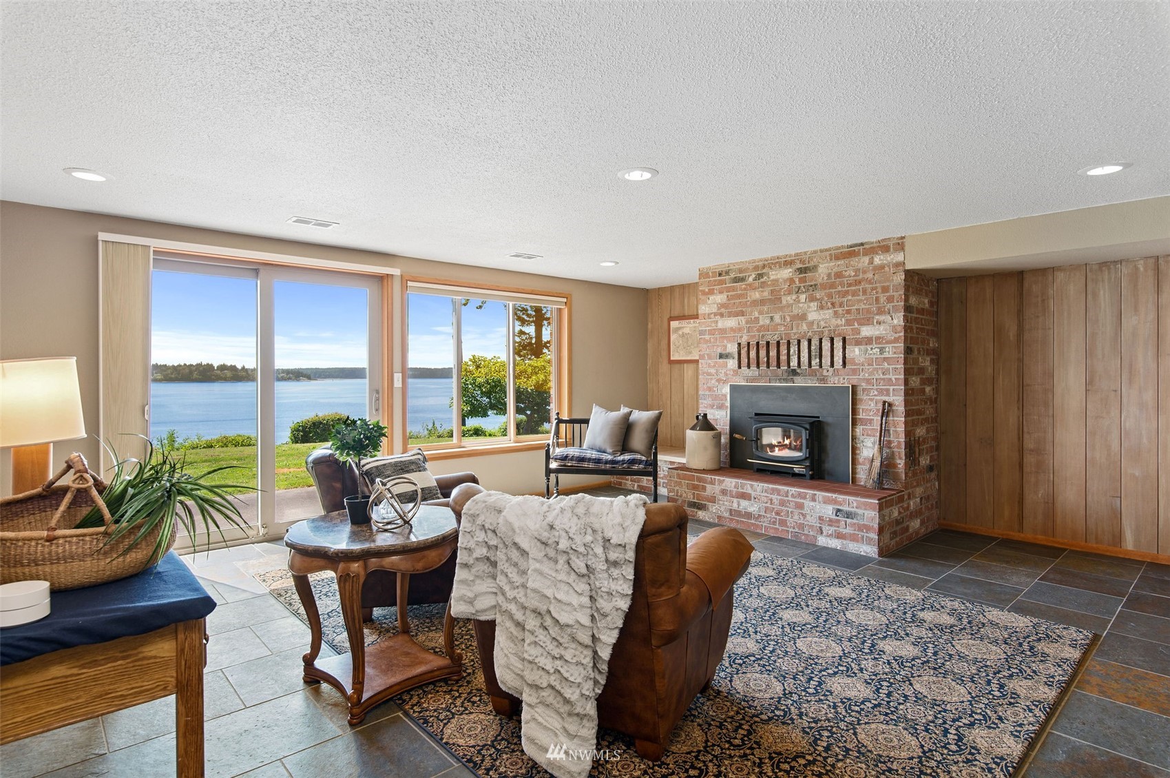 17510 88th Street Southwest Longbranch, WA 98351 - Photo 30 of 40 a living room with furniture a fireplace and a potted plant