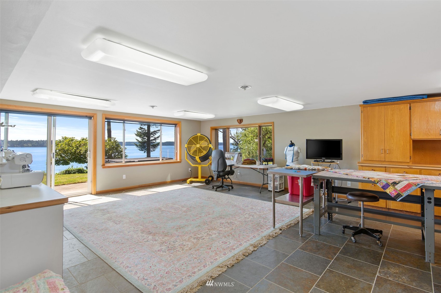 17510 88th Street Southwest Longbranch, WA 98351 - Photo 32 of 40 a living room with furniture a flat screen tv and a large window
