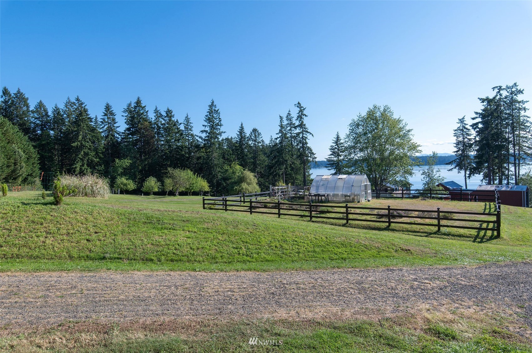 17510 88th Street Southwest Longbranch, WA 98351 - Photo 38 of 40 a green field with lots of trees in the background