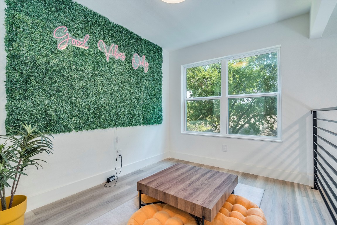 1902 Albury Cove, Unit C Austin, TX 78758 - Photo 12 of 25 a living room with a couch and a potted plant