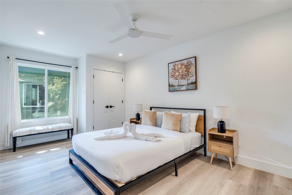 1902 Albury Cove, Unit C Austin, TX 78758 - Photo 13 of 25 a bedroom with a bed and a large window