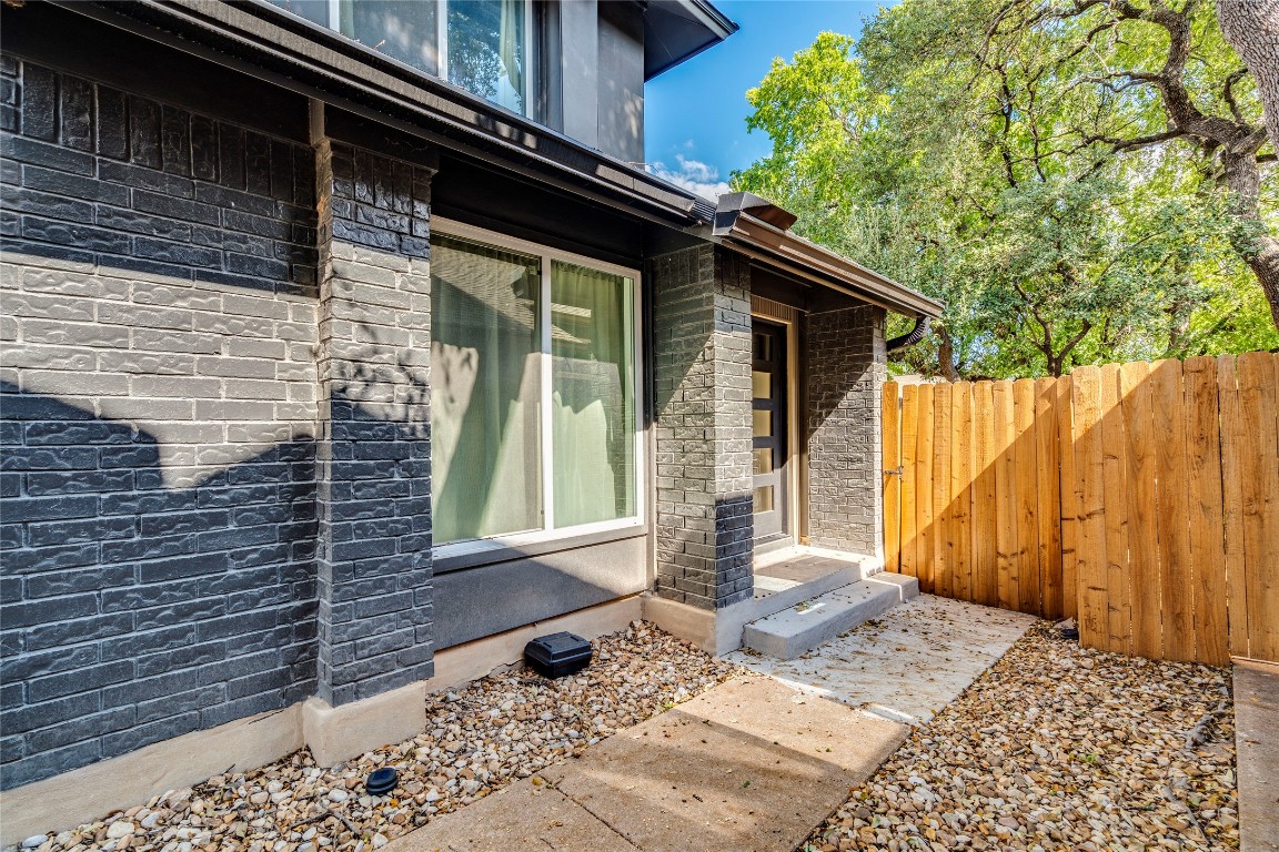 1902 Albury Cove, Unit C Austin, TX 78758 - Photo 21 of 25 a front view of a house with a yard