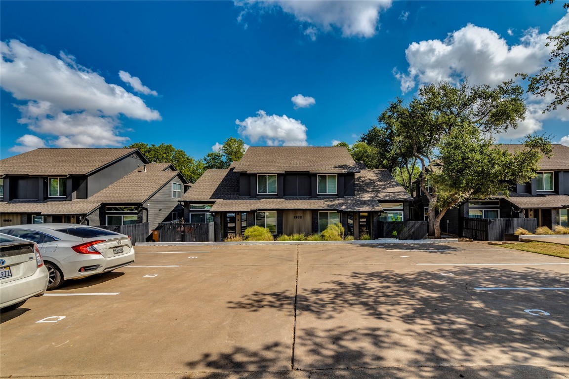 1902 Albury Cove, Unit C Austin, TX 78758 - Photo 22 of 25 a front view of a building with parking space