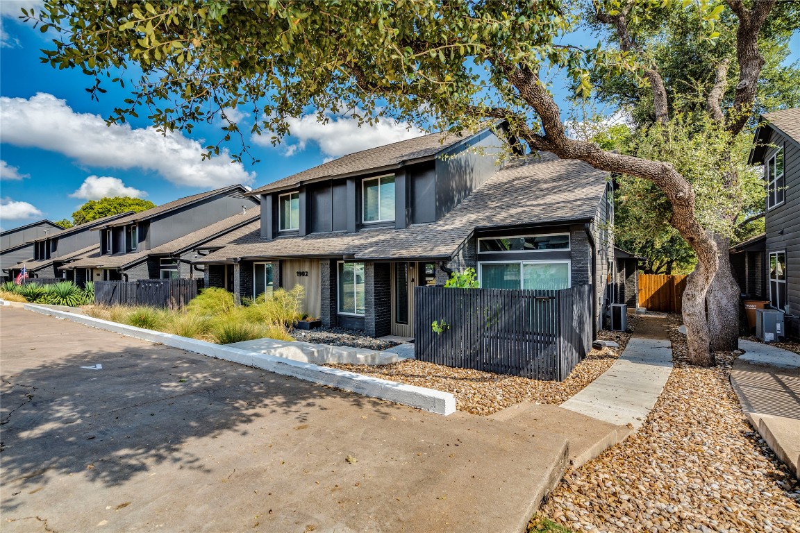 1902 Albury Cove, Unit C Austin, TX 78758 - Photo 24 of 25 a front view of a house with a yard