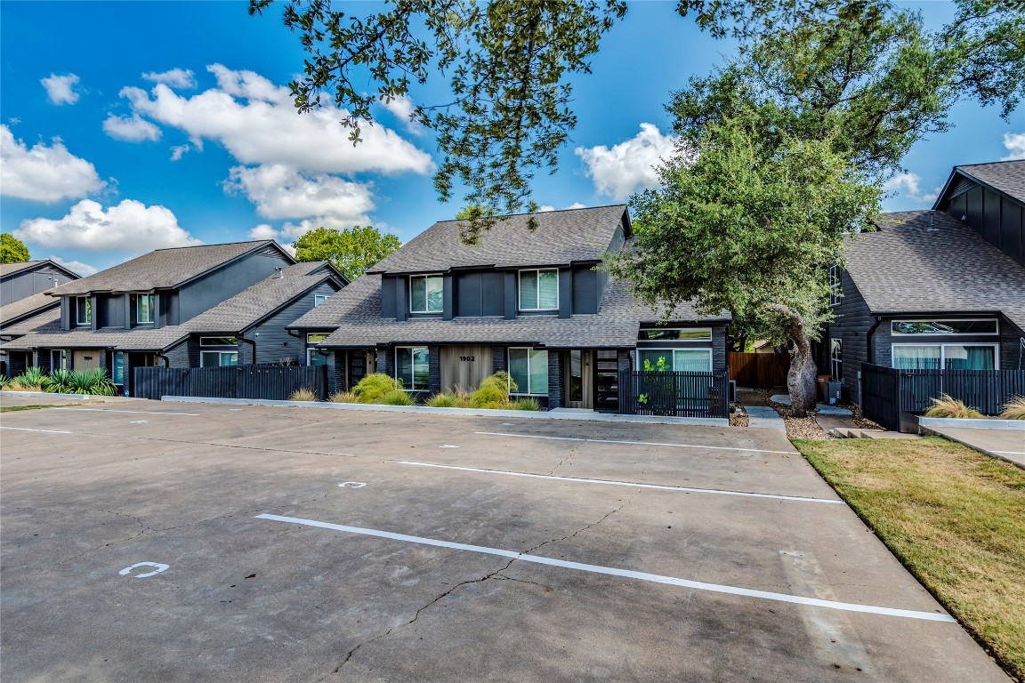 1902 Albury Cove, Unit C Austin, TX 78758 - Photo 25 of 25 a front view of a house with a yard and a garage