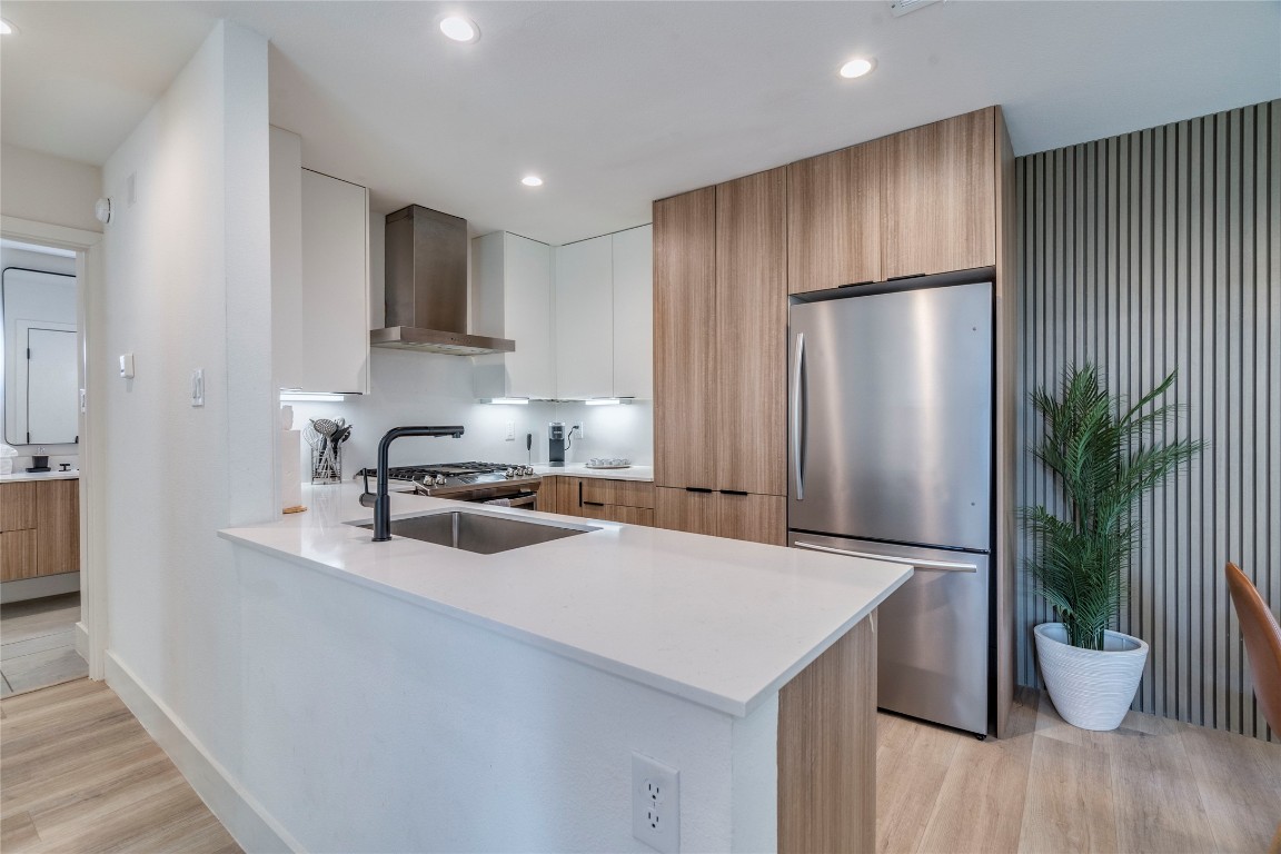 1902 Albury Cove, Unit C Austin, TX 78758 - Photo 3 of 25 a kitchen with a sink a refrigerator and a potted plant