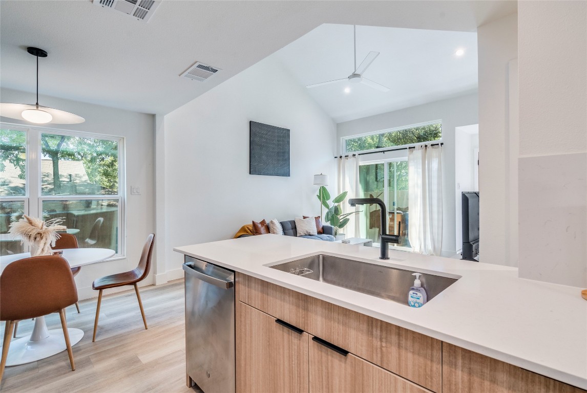 1902 Albury Cove, Unit C Austin, TX 78758 - Photo 5 of 25 a kitchen with a sink a counter top space and living room view