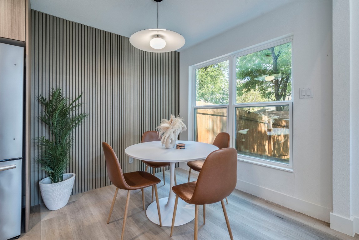 1902 Albury Cove, Unit C Austin, TX 78758 - Photo 6 of 25 a view of a dining room with furniture window and wooden floor