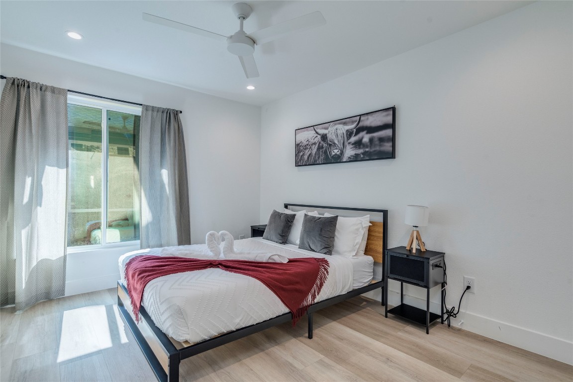 1902 Albury Cove, Unit C Austin, TX 78758 - Photo 9 of 25 a bedroom with a bed and a large window