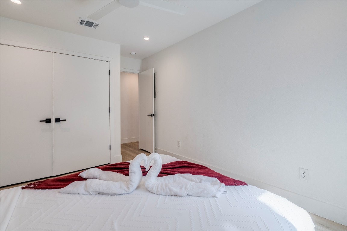 1902 Albury Cove, Unit C Austin, TX 78758 - Photo 10 of 25 a bedroom with a bed and a table