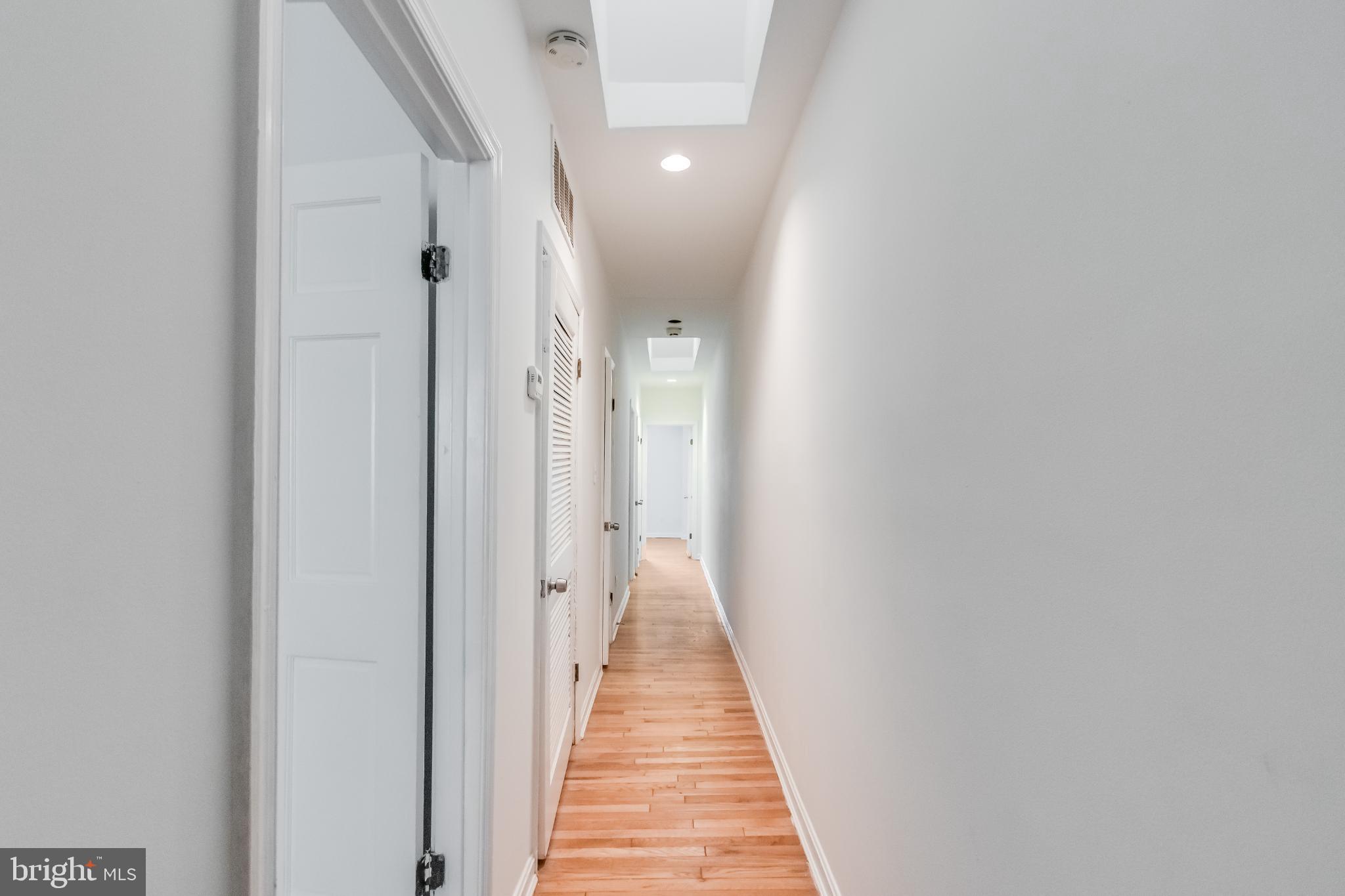 107 15th Street Northeast Washington, DC 20002 - Photo 20 of 30 a view of a hallway with wooden floor and a bathroom