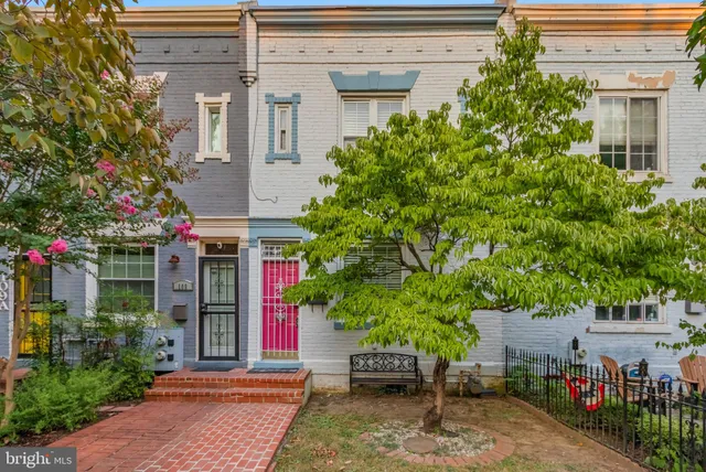 a front view of a house with plants