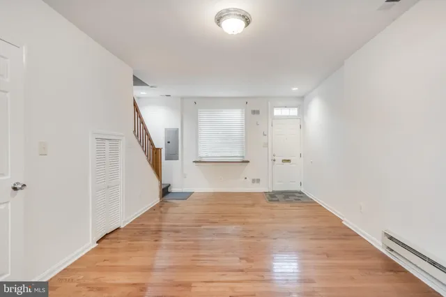 a view of an empty room with wooden floor