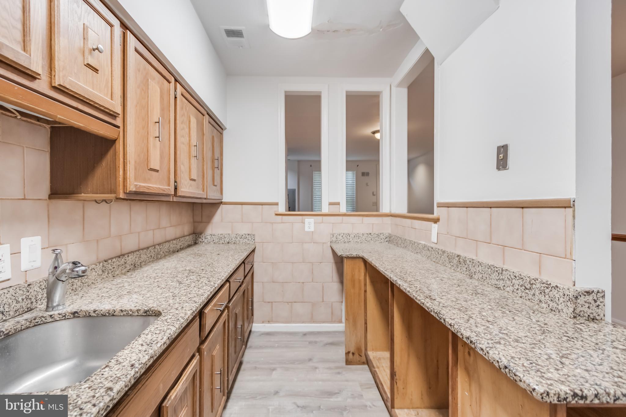 107 15th Street Northeast Washington, DC 20002 - Photo 8 of 30 a kitchen with granite countertop a sink and a granite counter tops