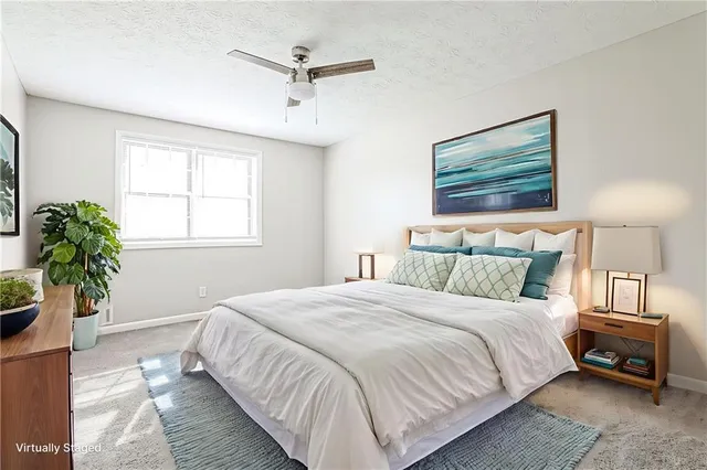 a bedroom with a bed and a potted plant