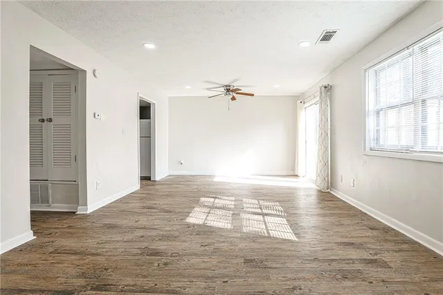 wooden floor in an empty room with a window