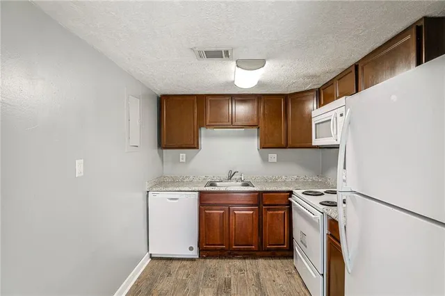 a kitchen with a sink stove and cabinets