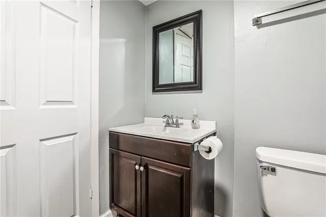 a bathroom with a sink toilet and mirror